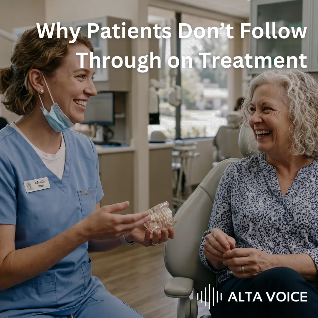 A hygienist laughing with an older patient in the operatory while holding a dental model to explain a diagnosis.